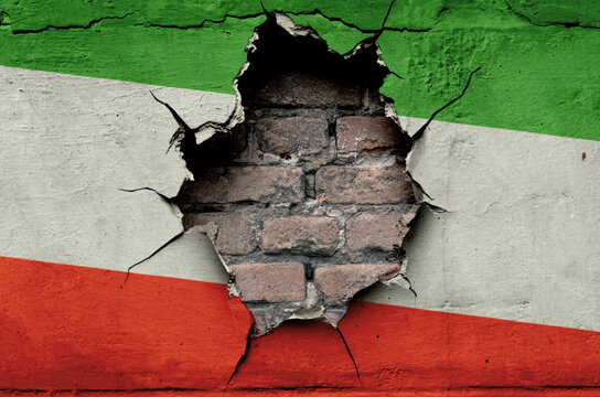 flag of the Islamic Republic of Iran are painted on an old wall with a cracked