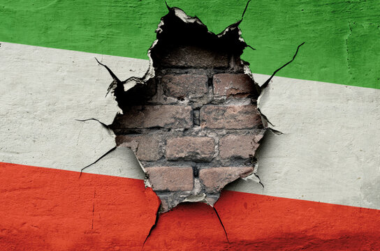 flag of the Islamic Republic of Iran are painted on an old wall with a cracked