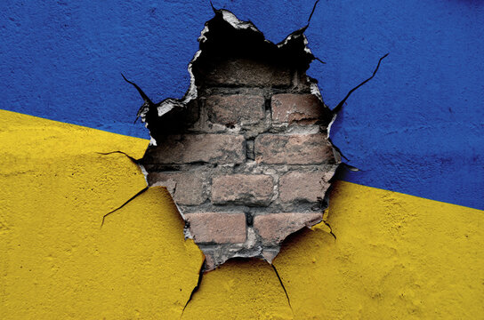 flag of the Ukraine are painted on an old wall with a cracked