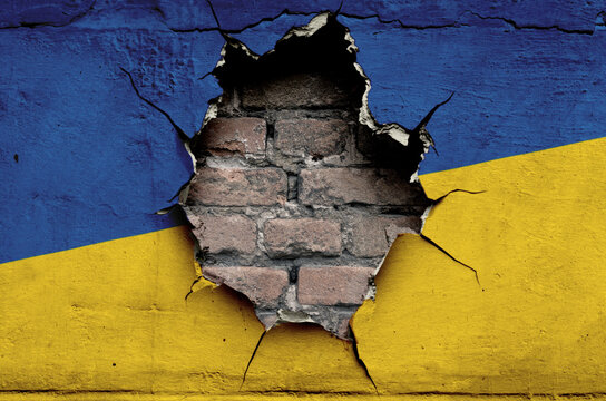 flag of the Ukraine are painted on an old wall with a cracked