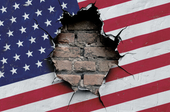 national flag of the United States of America is painted on an old wall with a large hole
