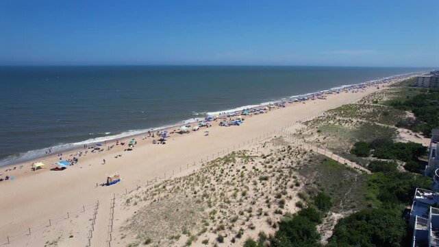 angled drone flyover Fenwick Island Delaware beach summer day