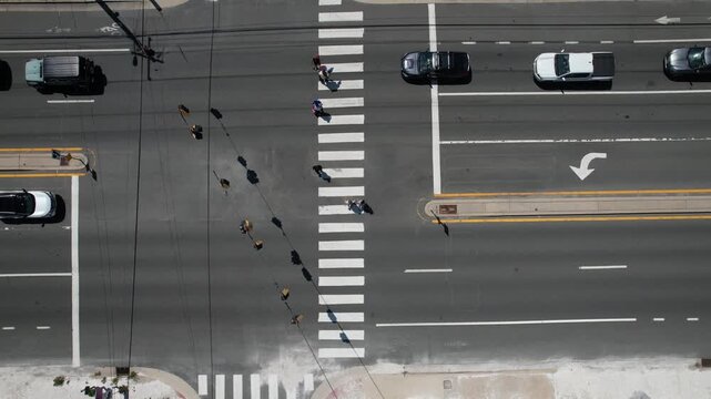 looking down from drone over a crosswalk in a beach town