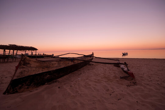 Madagascar, Tulear, Ifaty, pink sunrise with wooden dug-out