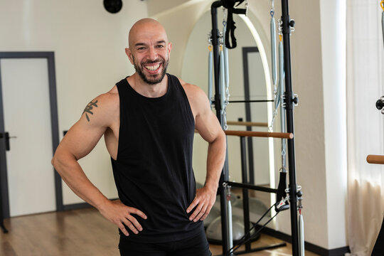 Fitness instructor smiling in modern pilates studio