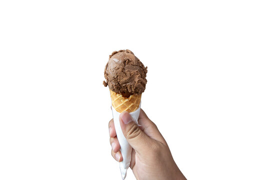 Person holding a single scoop of chocolate ice cream in a waffle cone wrapped with a white napkin.