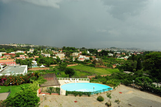 Madagascar, Antananarivo, Ivandry, upper view on residential houses and rice field next to swimming pool