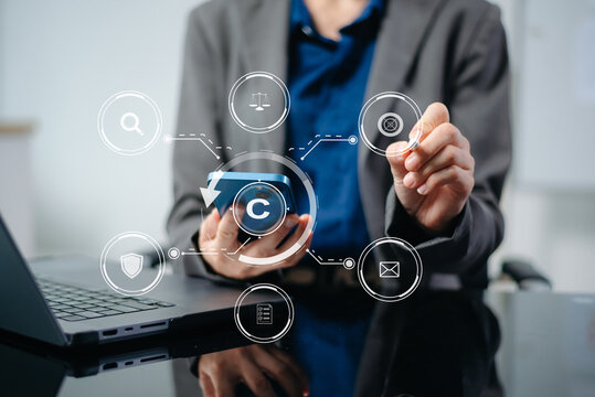 Copyright or patent concept, Business team analyzing data and using smart phone and tablet with virtual screen copyright icon trademark license, Creation ownership against piracy. at office.
