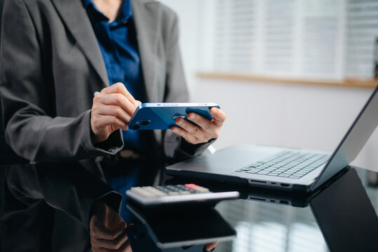 Close up of businesswoman or accountant hand typing laptop working to calculate on desk about cost at home office.