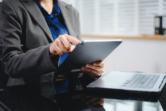 Businesswoman hands typing on smartphone and laptop keyboard in morning light computer, typing, online in office