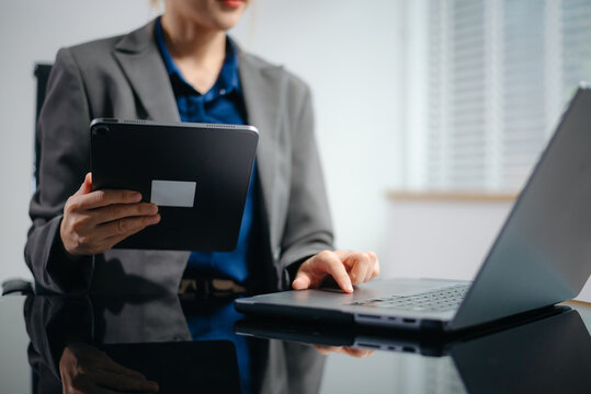 Businesswoman hands typing on smartphone and laptop keyboard in morning light computer, typing, online in office