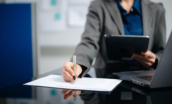 business documents on office desk with laptop and smart phone and graph business diagram and man working in morning light