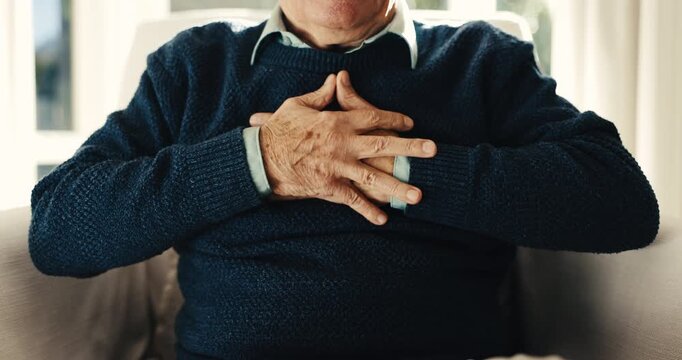 Elderly, man and hands in retirement home with chest pain, acid reflux symptoms and medical problem. Uncomfortable, senior person and heartburn in living room with indigestion, illness and disease.