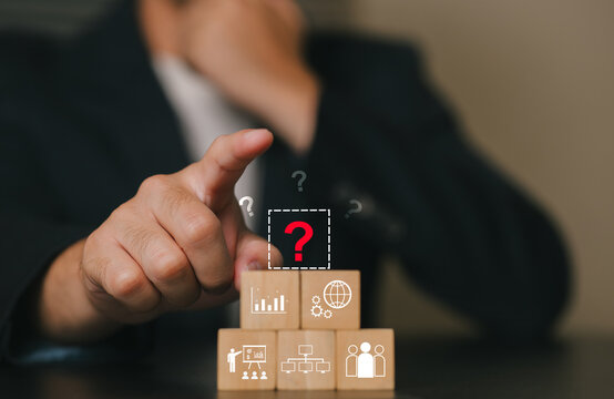 Businessman Analyzing Data and Growth Strategy Using Wooden Blocks and Digital Icons