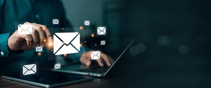 Person interacting with email icons on a digital interface
