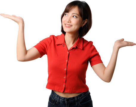 Asian woman presenting with open hands and cheerful smile in red shirt isolated on transparent background for comparison or promotion
