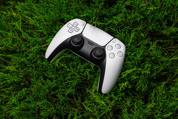 Modern white gamepad on green background © solidmaks