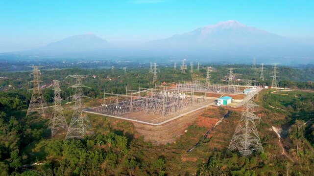 Aerial view of Ampel 150kV Substation with Mount Merbabu and Mount Merapi in the background, Kecamatan Ampel, Jawa Tengah, Indonesia.