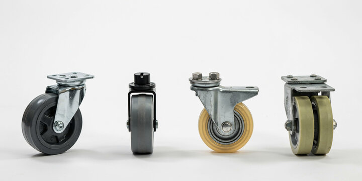 Four industrial swivel casters with different wheels on a plain white background