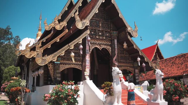Wooden Lanna temple viharn with gold carving in Mae Chaem