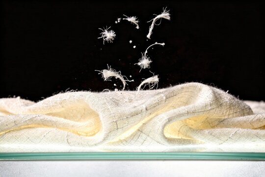 Ivory raw silk fabric texture closeup with soft tactile natural slubs