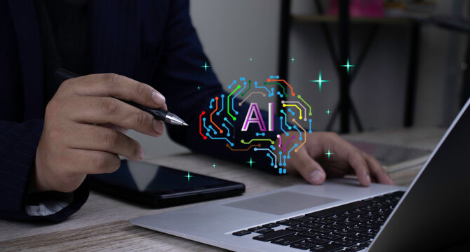 Businessman holding pen and working on laptop computer with smartphone on desk, presenting AI brain circuit hologram. Concept of artificial intelligence analysis, digital technology, and innovation.