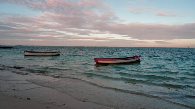 Small boats bobbing at sea after sunset, Belle Mare beach in Mauritius