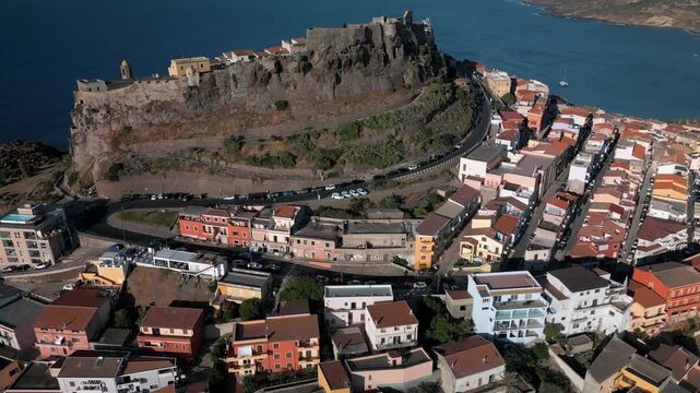 Panoramic aerial view of the Castelsardo, a medieval town in northern Sardinia (Sassari province) on the Gulf of Asinara. It features cascading, colorful houses and a historic fortress.