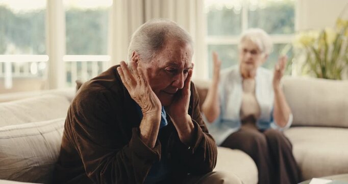 Argument, upset and senior man on sofa in home with fighting, disagreement or divorce on weekend. Stress, couple and elderly person in living room with marriage fail, breakup or conflict in house.