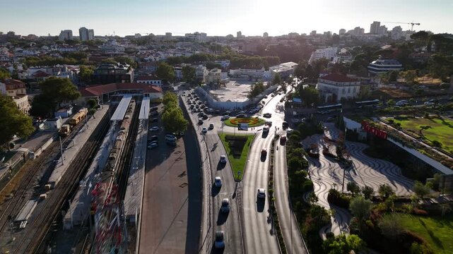 Aerial view of Avenida Marginal with the railway station and coastal road traffic in Cascais, Lisboa, Portugal.