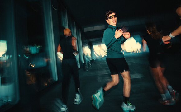 People running together in an urban run club bring energy to training outdoors