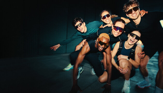 Her running group huddle brings friends together in a playful fitness portrait