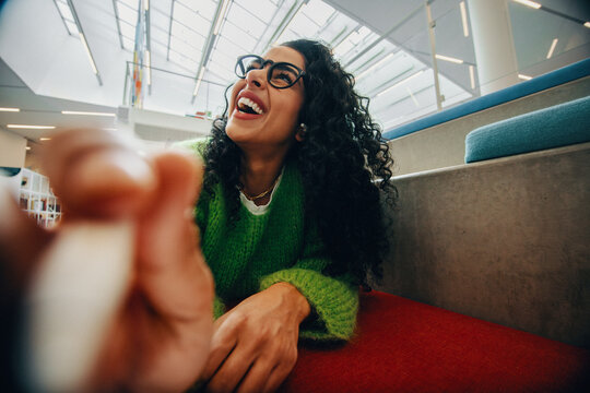 The happy woman with glasses brings a cheerful expression to this indoor portrait