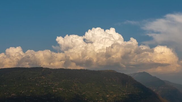 4K Timelapse of dramatic cumulonimbus clouds illuminated in sunset rolling over the mountains over Bijali Mahadev temple during monsoon. Storm clouds on mountains in Kullu, Himachal Pradesh, India. Tr