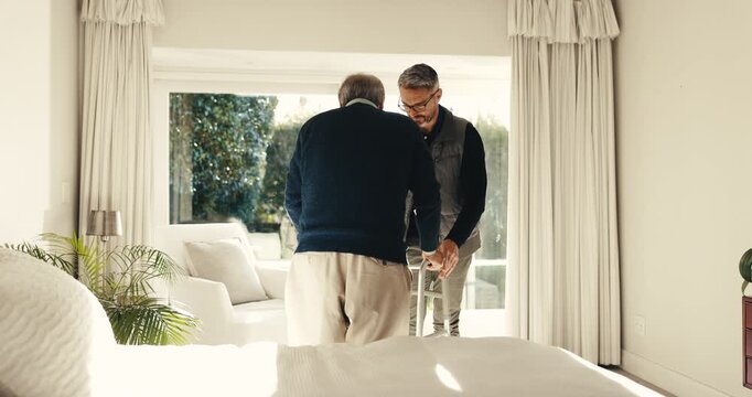 Caregiver, help and old person with walker in home for support, assistance or physical therapy. Man, senior patient with a disability and frame in assisted living facility for physio and recovery