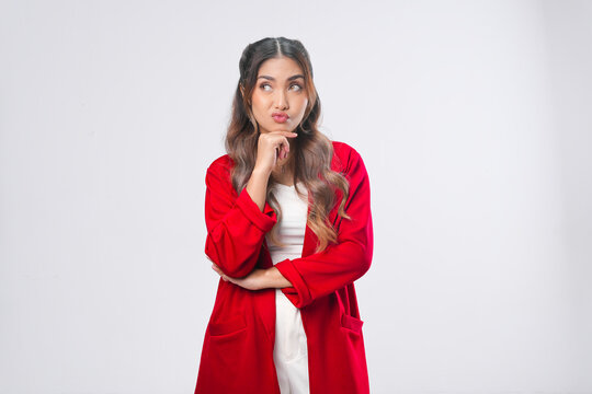 Confused young Asian woman in a red jacket is thinking hard to find idea.