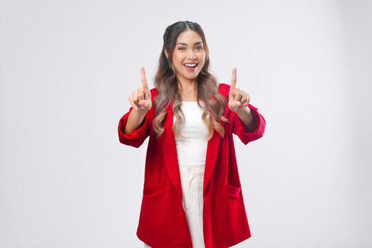 Cheerful Asian young woman is raising her fingers showing number gesture.