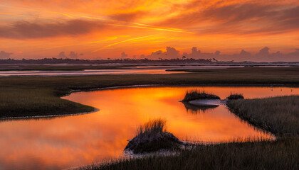 Fototapeta premium Saltwater Marsh Reflecting Dramatic Sunset Sky