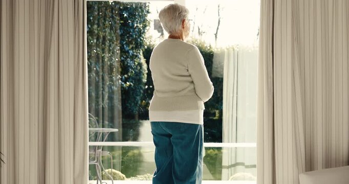 Thinking, calm or elderly woman at window with inspiration, daydreaming or memory in chill mindset. Retirement, back and senior person with reflection, flashback and peaceful perspective in home.