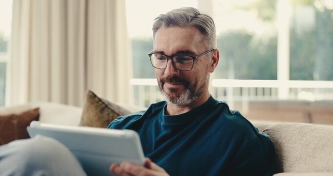 Happy, man and scroll in home with tablet, reading ebook and internet connectivity on calm weekend. Mature person, smile and relax on lounge with tech, research and thinking for online story choice.