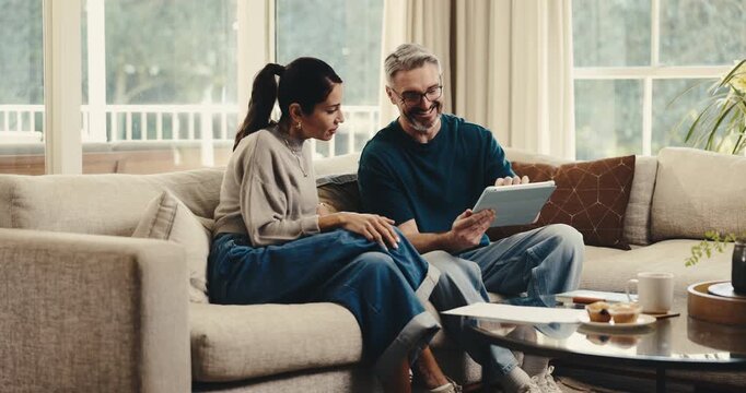 Finance, tablet and couple high five in house for insurance payout, loyalty reward and support. Happy, mature people and celebration with digital wallet for credit score goal, tax refund and cashback