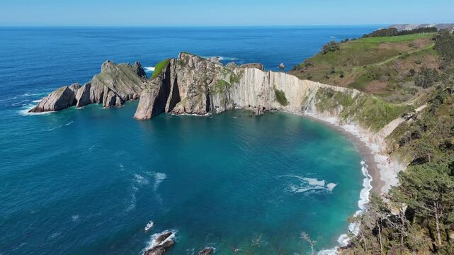 Aerial view of Playa del Silencio cliffs with tilt down camera motion in Asturias Spain
