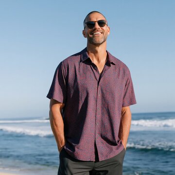 Smiling man in short sleeve shirt on sandy beach for summer lifestyle banner and travel portrait background