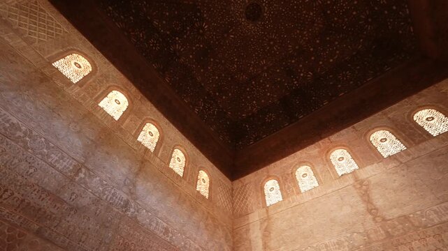 Decorated room and yard in Alhambra, Granada. Wall details and Magnificent moorish interior in Alhambra palace, Granada.