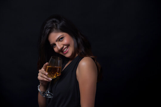 Portrait of a woman with a glass of wine smiling