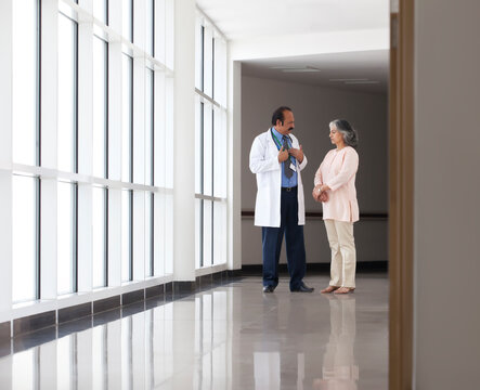 Doctor discussing patient care in hospital corridor