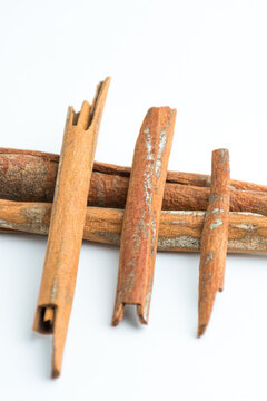 Cinnamon sticks arranged in crossed and star pattern isolated on white background