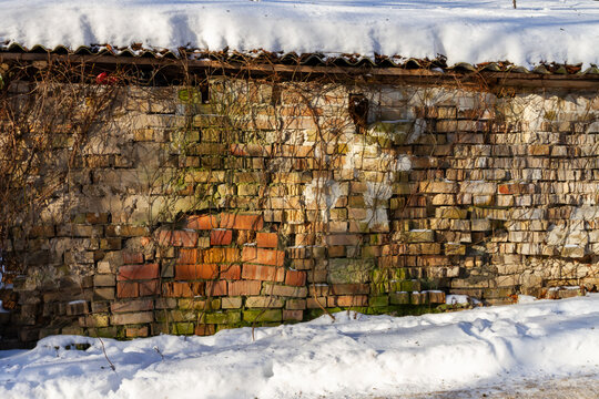 Old abandoned brick wall in winter. Architectural detail.