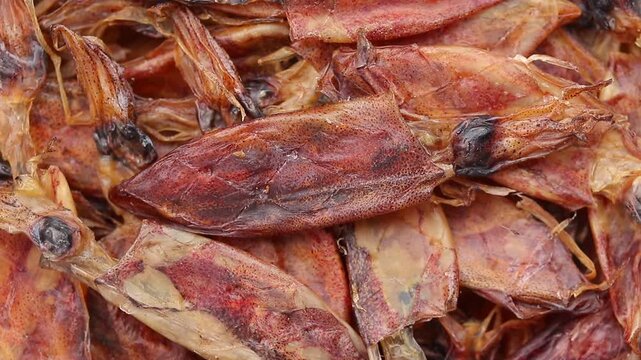Pile of dried squids slowly rotating, Top view shot