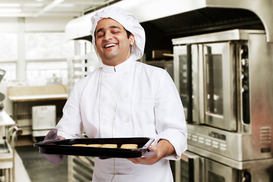 Chef with a tray of baked cookies 